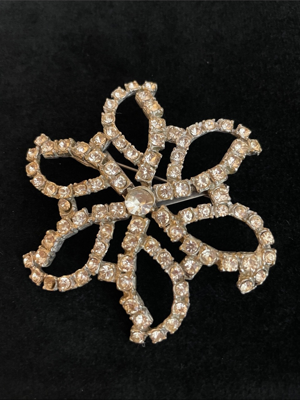 Vintage silver-tone rhinestone ribbon brooch features a sparkling shine!